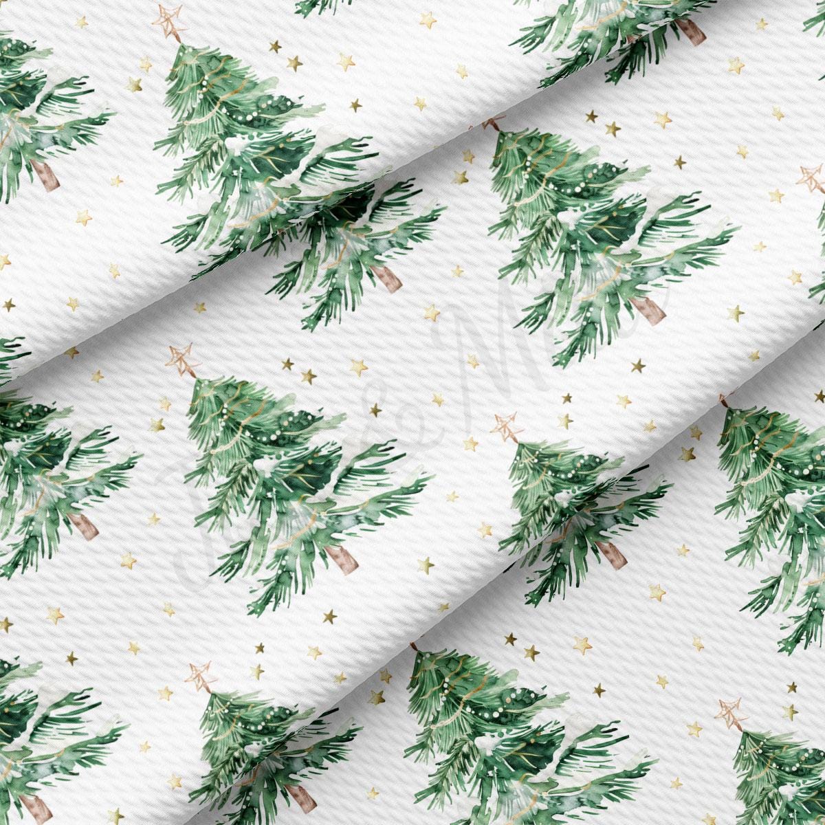 a repeating pattern of green Christmas trees with gold stars scattered throughout the background.