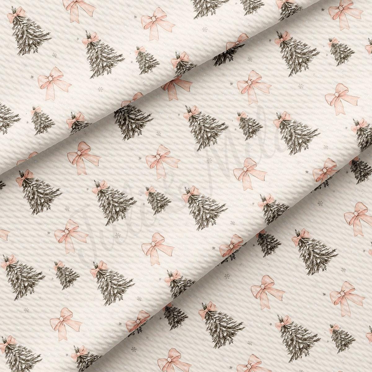 a repeating pattern of Christmas trees with pink bows on a white background.