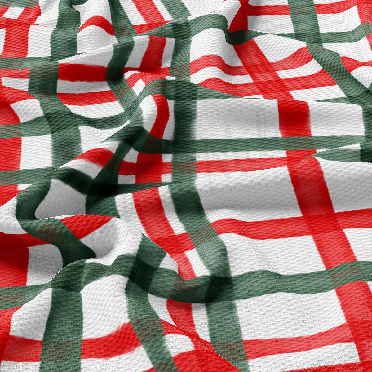 a close-up view of a fabric with a repeating pattern of red and green stripes, resembling a plaid or checkered design.