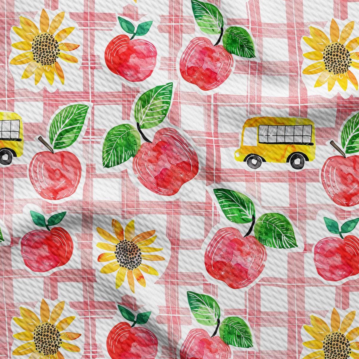 a pattern of apples, sunflowers, and a bus on a checkered