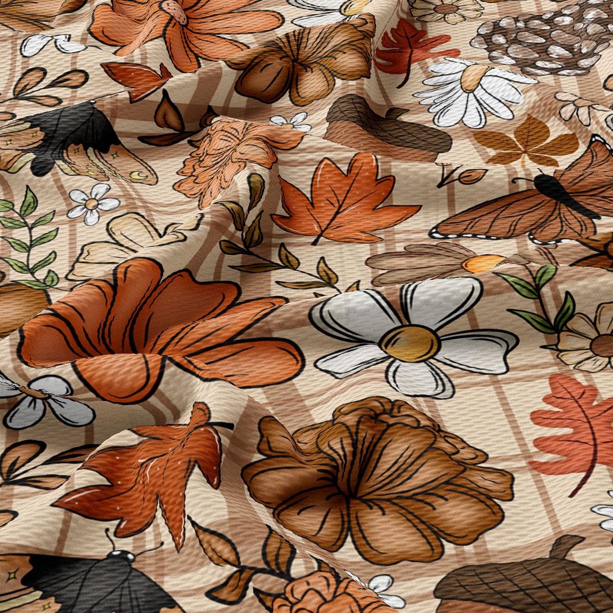The image is a close-up view of a fabric with a variety of autumn-themed flowers and leaves, including flowers, leaves, and acorns, creating a vibrant and colorful pattern.