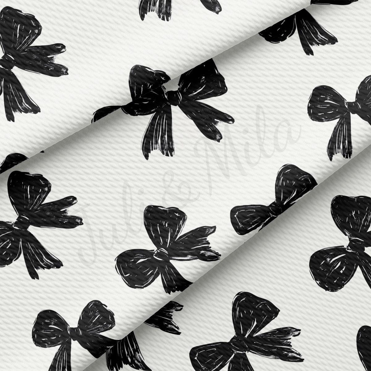 a repeating pattern of black bows on a white background.
