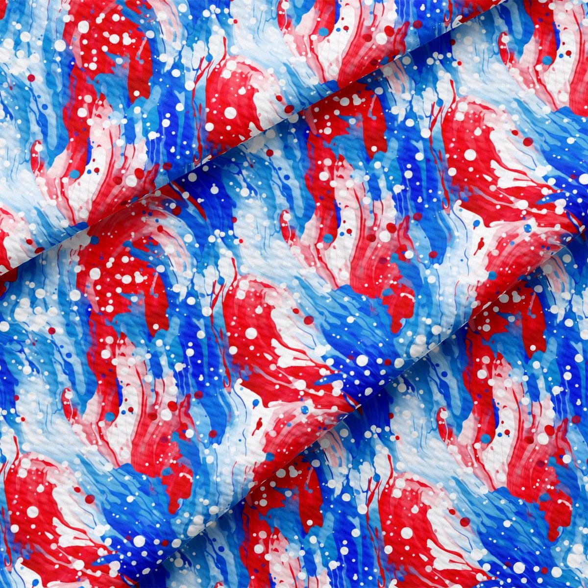 a red, white and blue fabric with red and blue paint splattered on