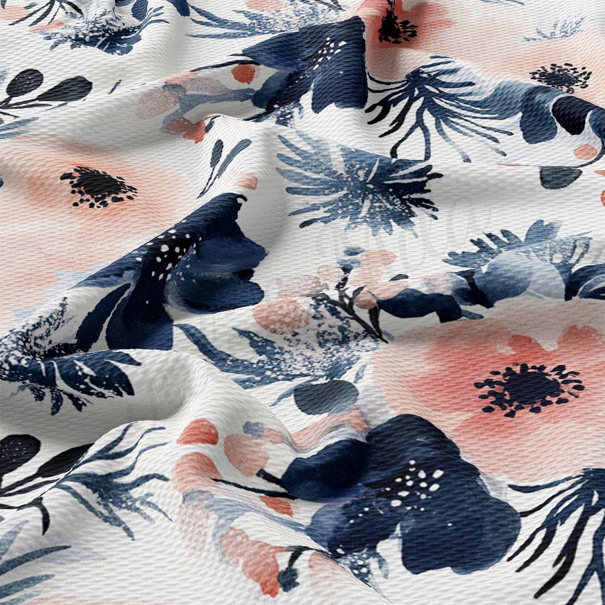 a close-up view of a fabric with a floral pattern in shades of blue, pink, and white. The pattern consists of various flowers and leaves, creating a visually appealing and textured design.