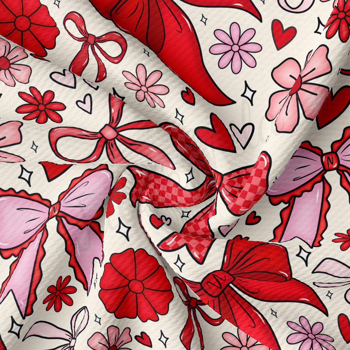 The image is a close-up of a fabric with a repeating pattern of red bows, flowers, and hearts.