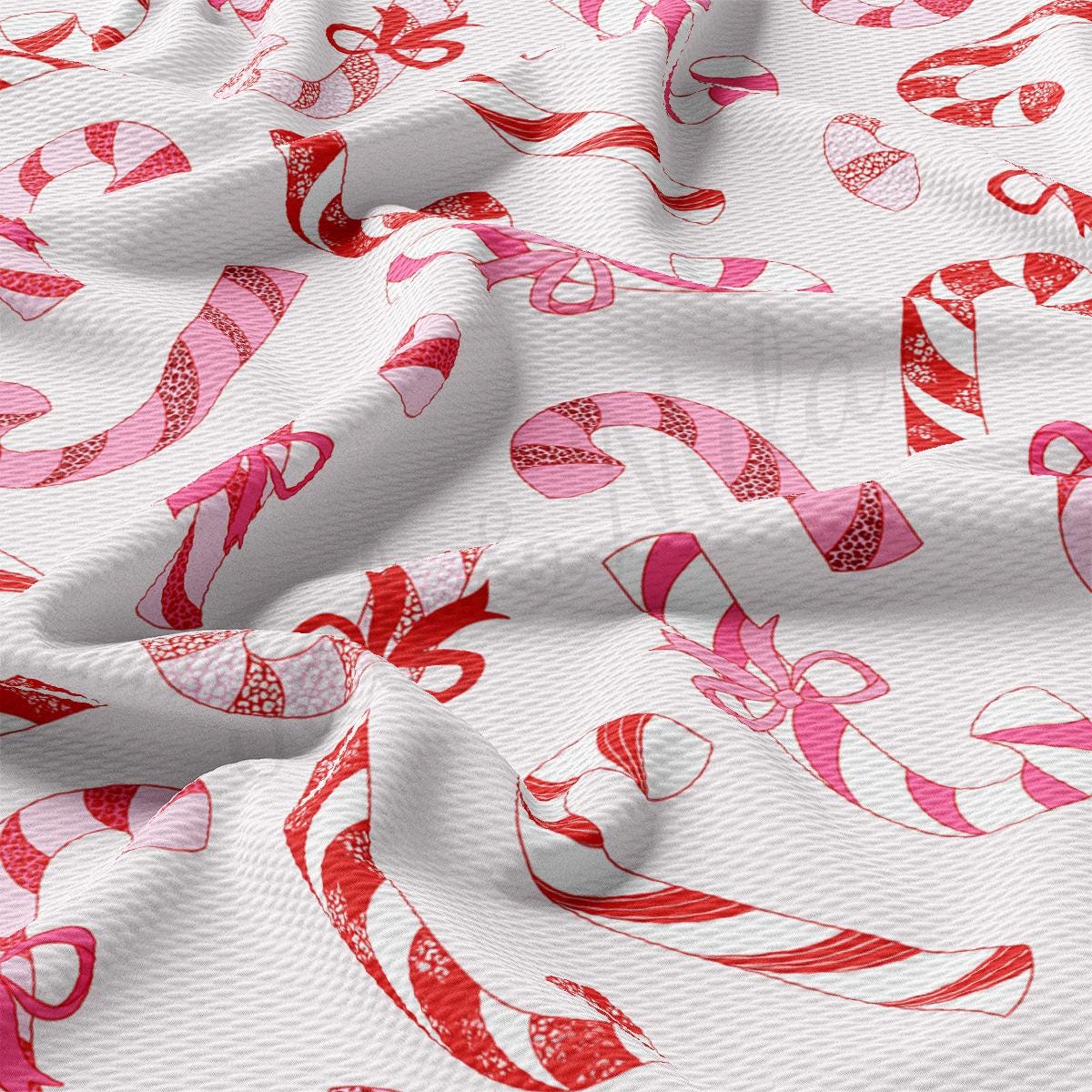 a close up of a white fabric with pink and red designs