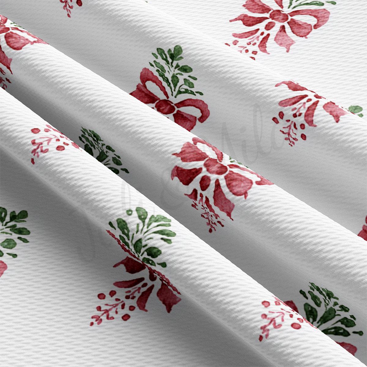 a close-up view of a fabric with a repeating pattern of red and green floral designs.