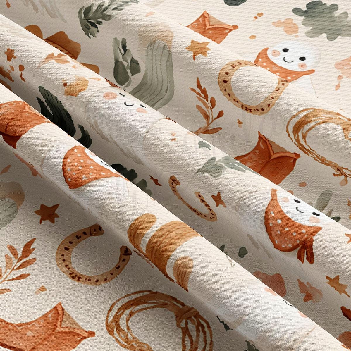 The image is a close-up of a fabric with a repeating pattern of various animal and plant illustrations, including a smiling face, a snake, and a cactus.