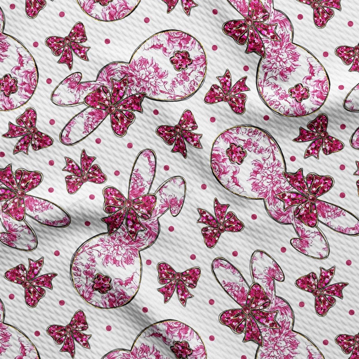 a pink and white fabric with pink bows