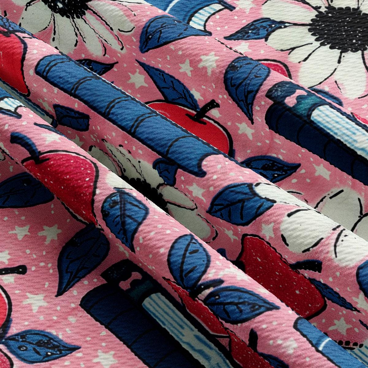 a close up of a pink fabric with blue and red flowers