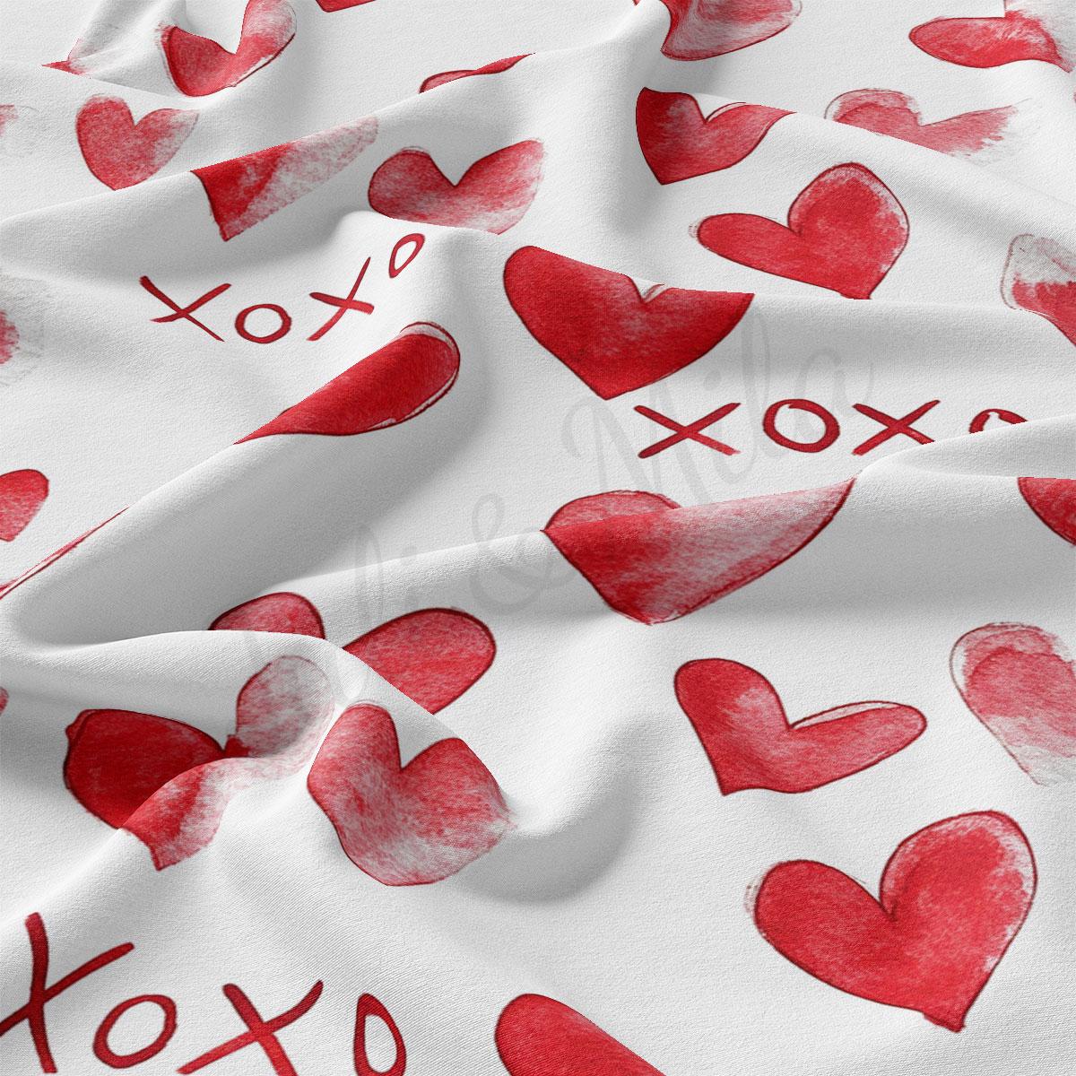 a close-up view of a white fabric with a repeating pattern of red hearts and the word "XOXO" written in red.