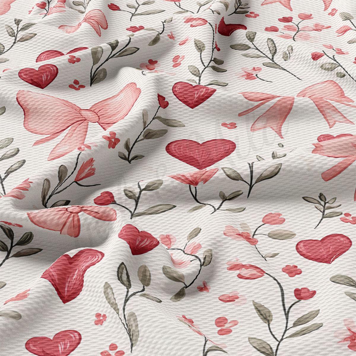 a close-up view of a fabric with a floral pattern. The pattern consists of various pink flowers, leaves, and bows, creating a visually appealing and textured design.
