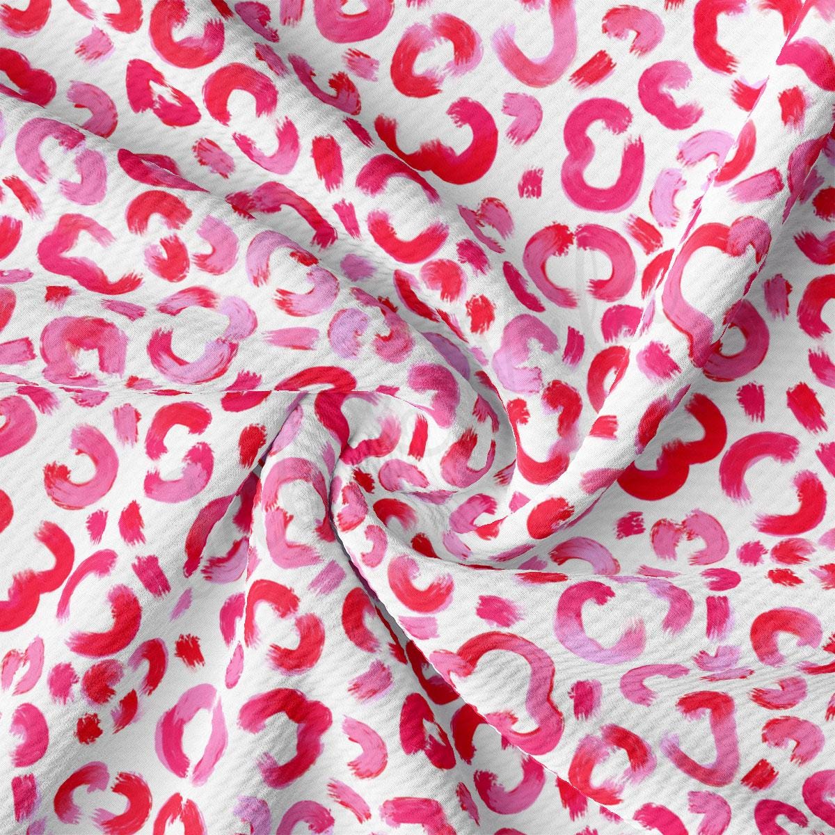 a red and white fabric with red and pink spots