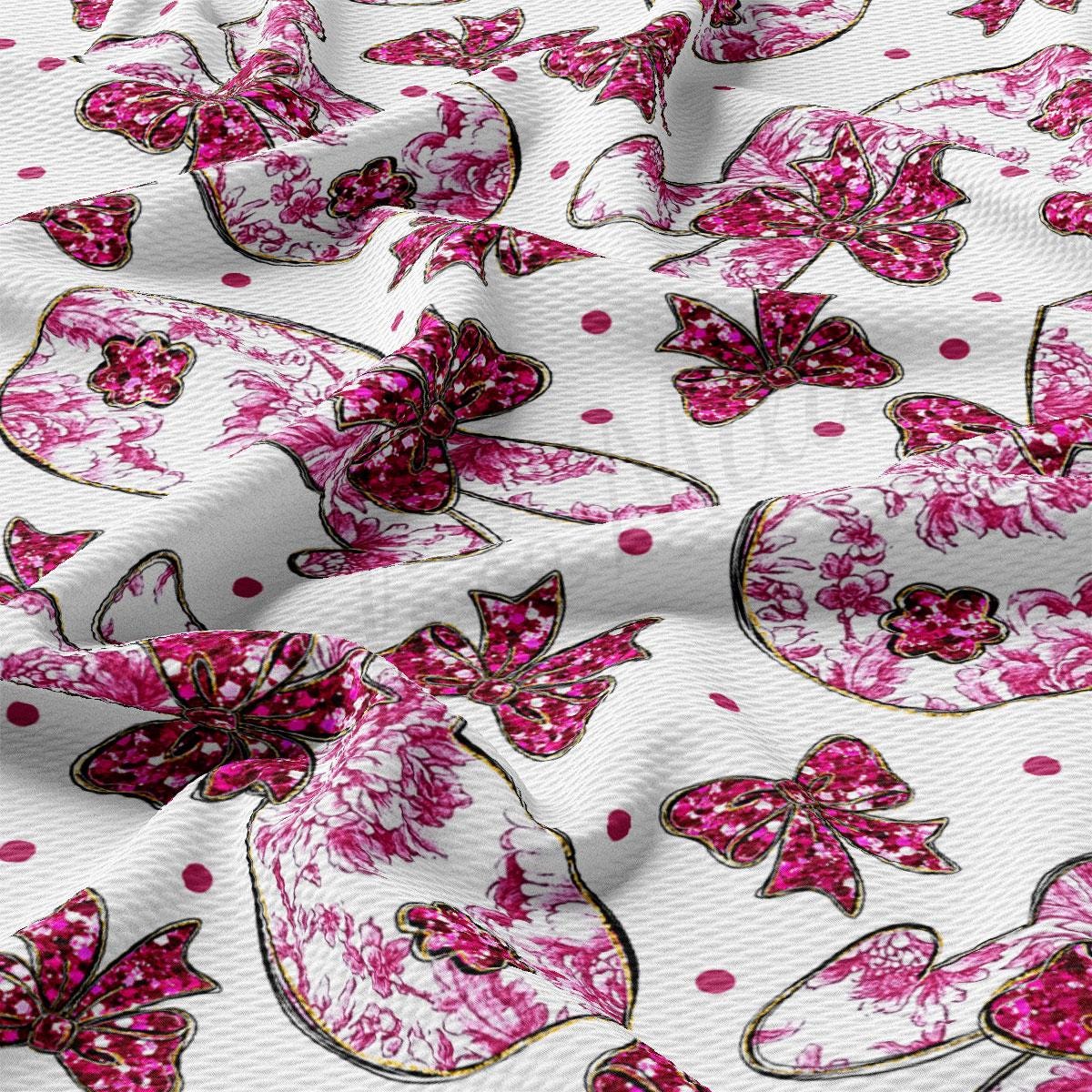a close up of a pink and white fabric with butterflies on it