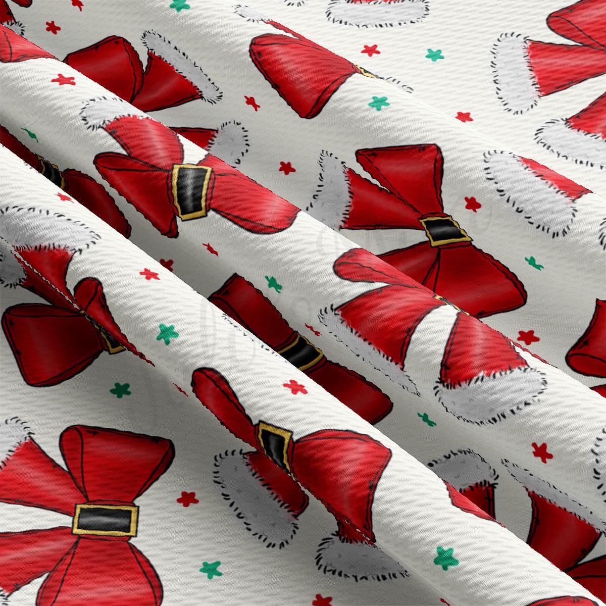 a close-up view of a fabric with a repeating pattern of red Santa hats and green stars.