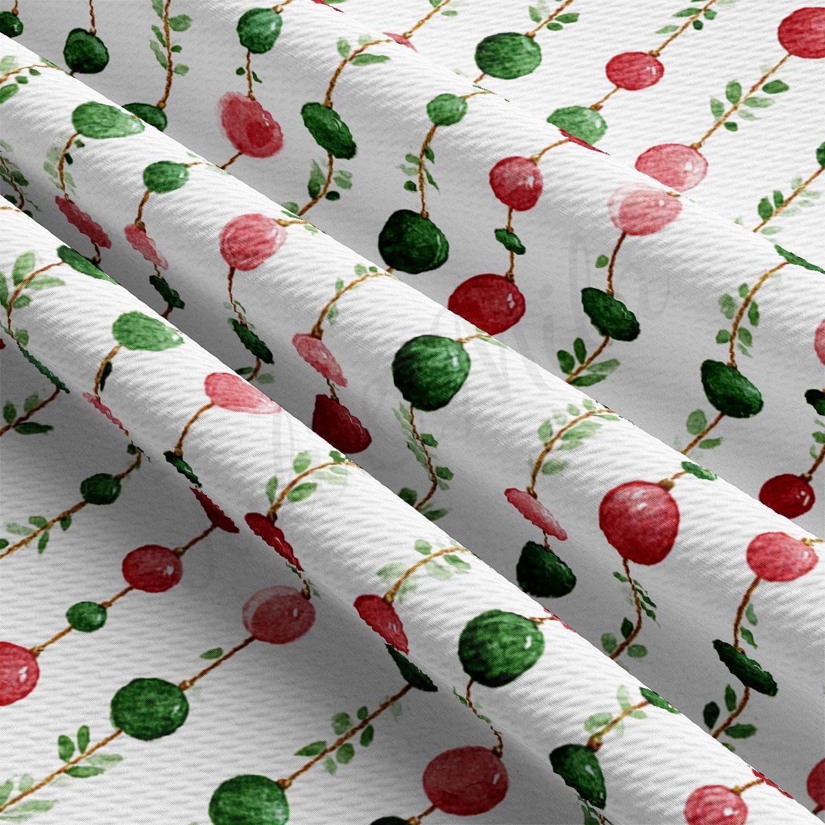 a close-up view of a fabric with a repeating pattern of red and green circles and leaves.