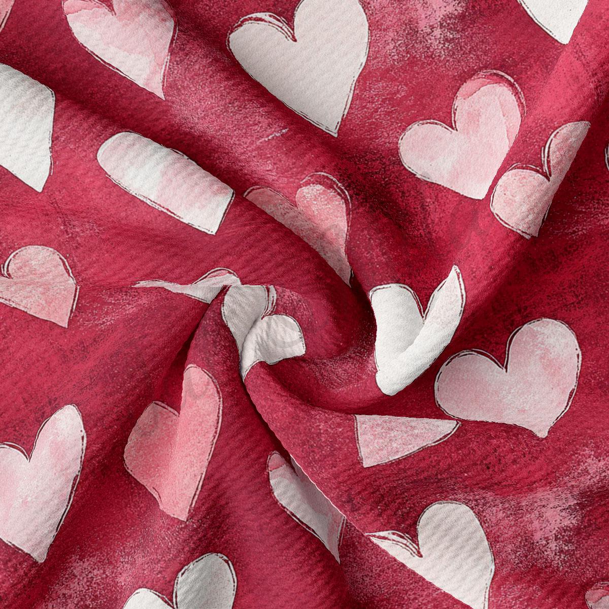 a close-up view of a fabric with a repeating pattern of white hearts against a red background.