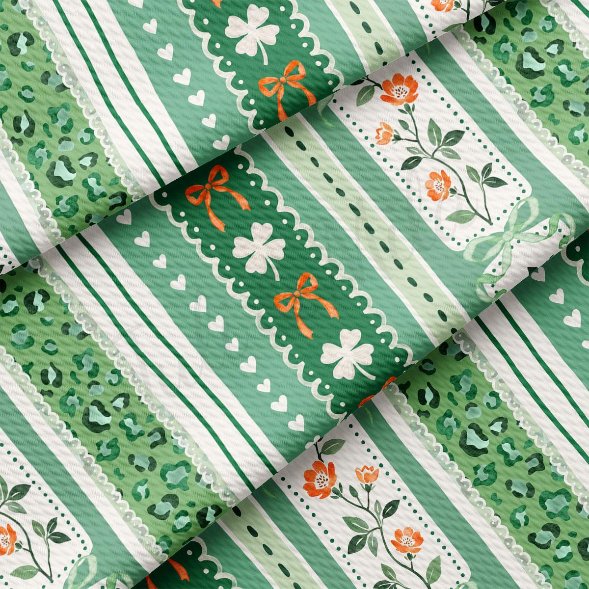 The image is a close-up view of a fabric with a repeating pattern of green and white stripes, along with floral and geometric designs. The pattern includes clover leaves, flowers, and bows, creating a visually appealing and intricate design.