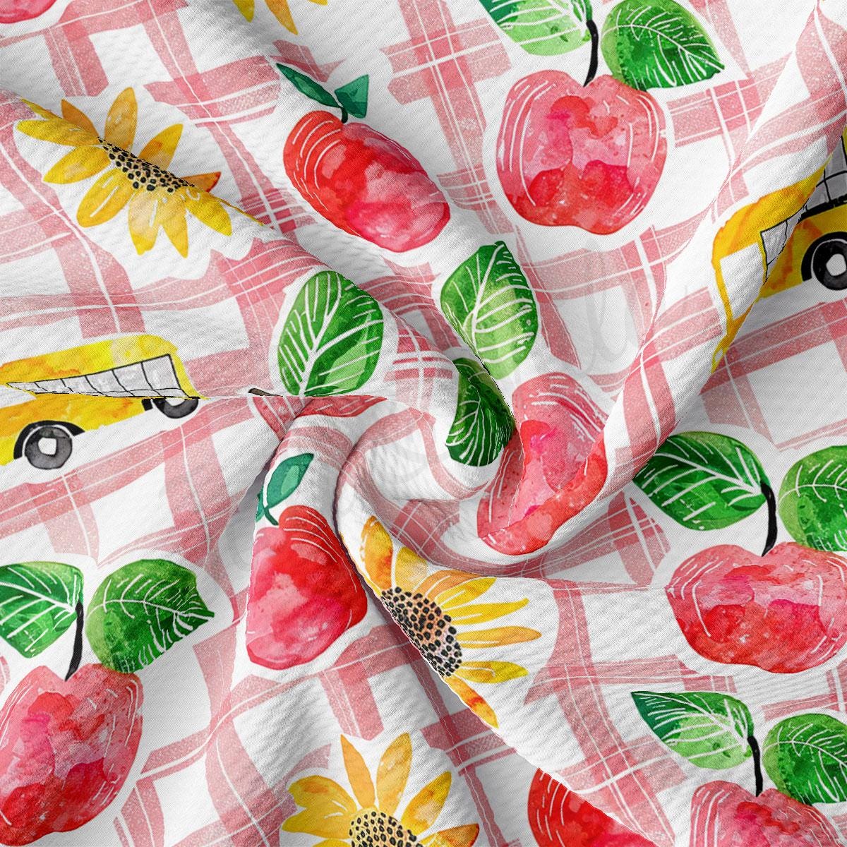 a pattern of apples, sunflowers, and a bus on a checkered