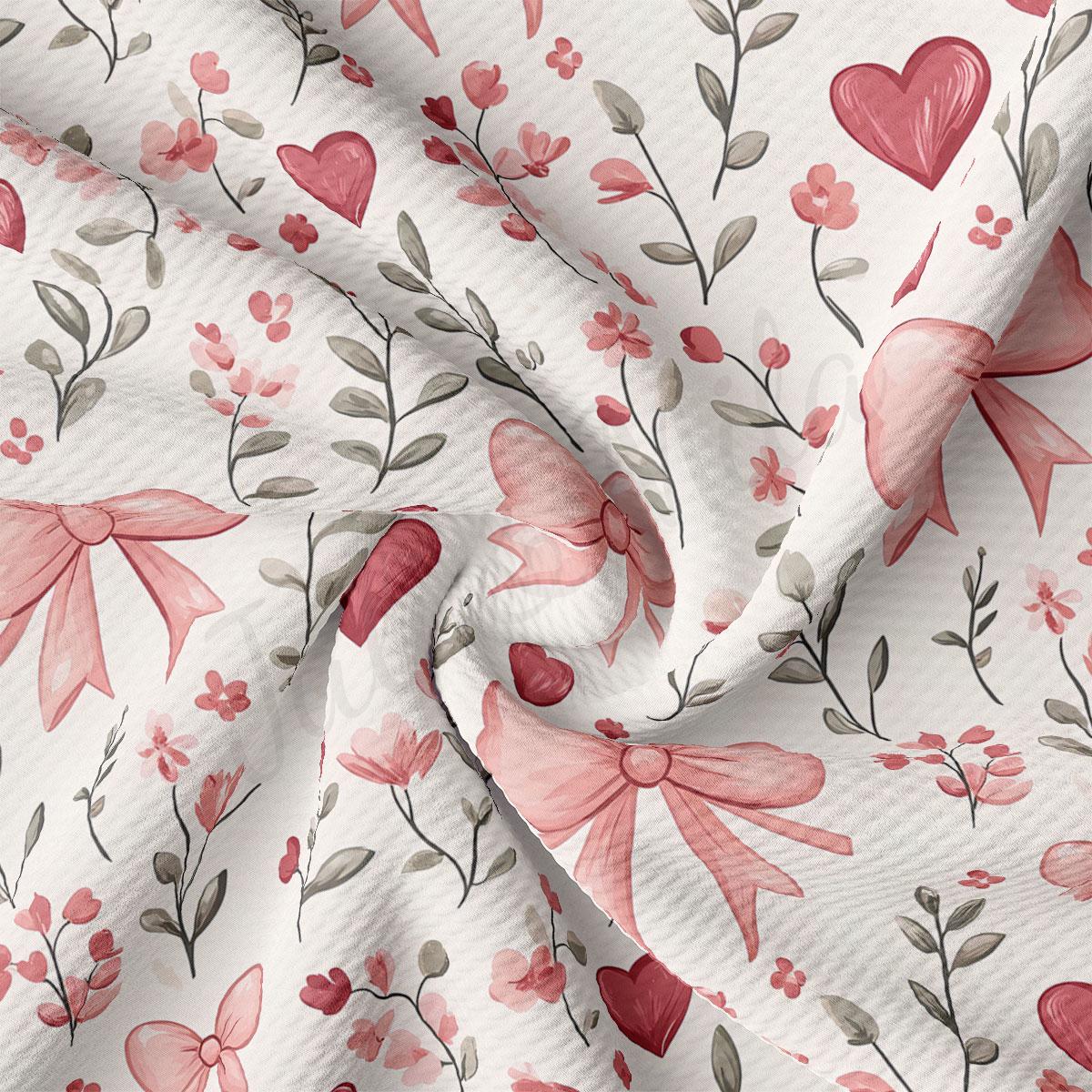 a close-up view of a fabric with a floral pattern. The pattern consists of pink flowers, leaves, and bows, creating a visually appealing and delicate design.