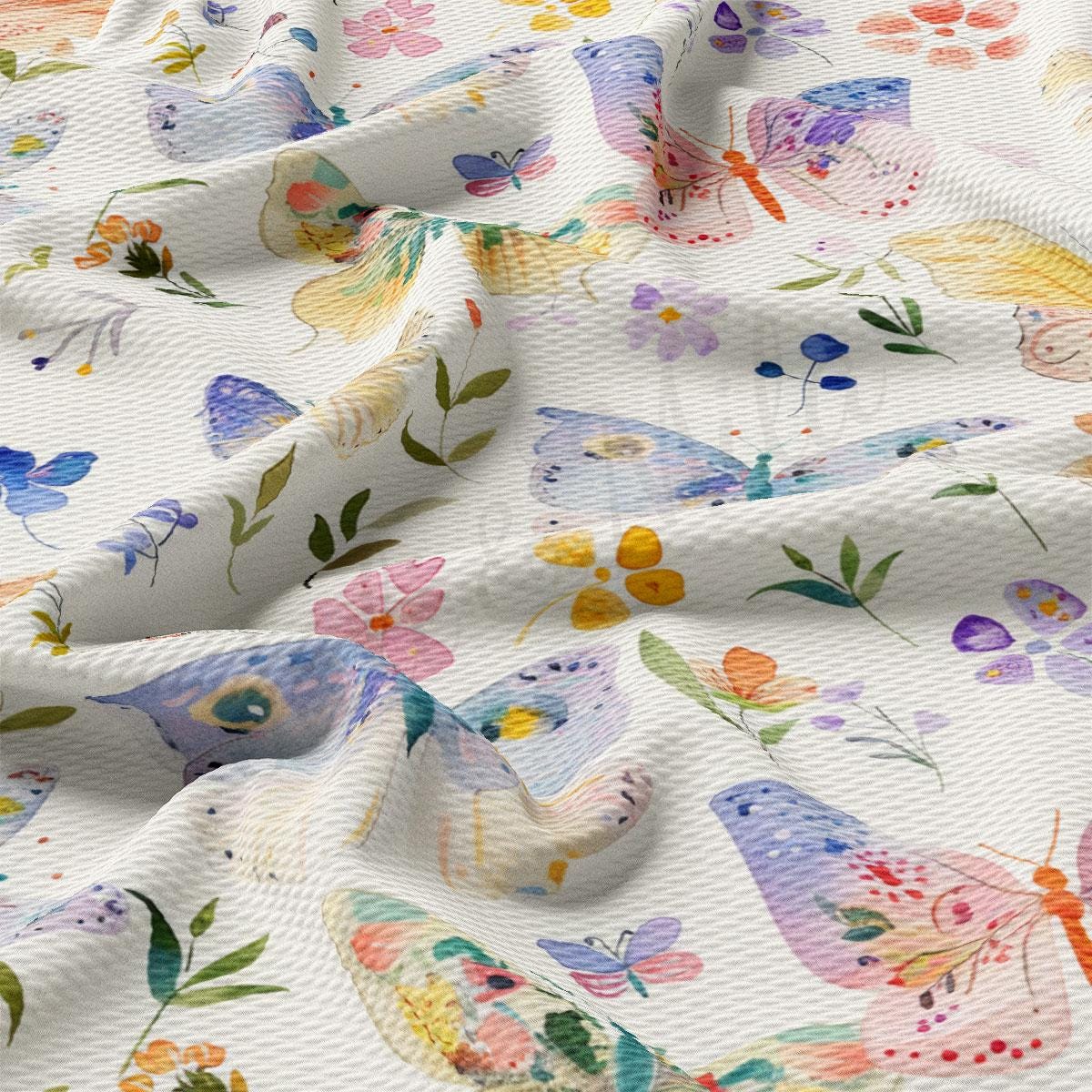 a close up of a white fabric with colorful flowers and butterflies