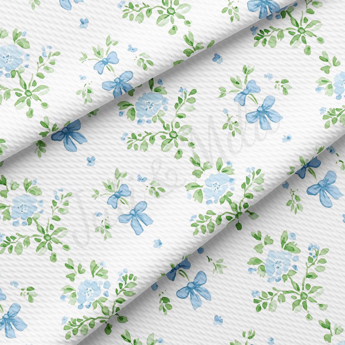 a repeating pattern of blue flowers and green leaves on a white background.