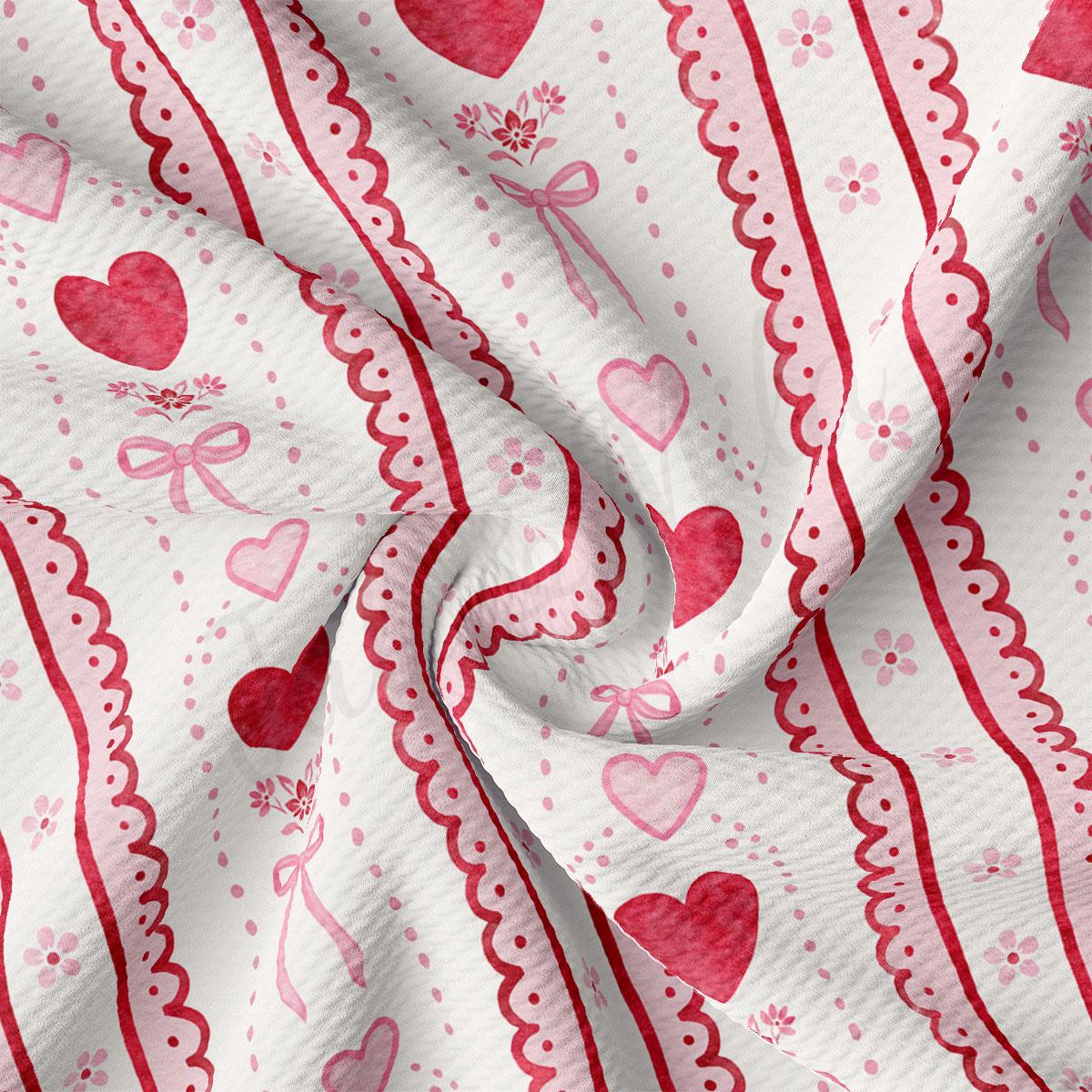 The image is a close-up of a fabric with a repeating pattern of pink hearts and red bows. The fabric appears to be crumpled, giving it a soft and delicate appearance.