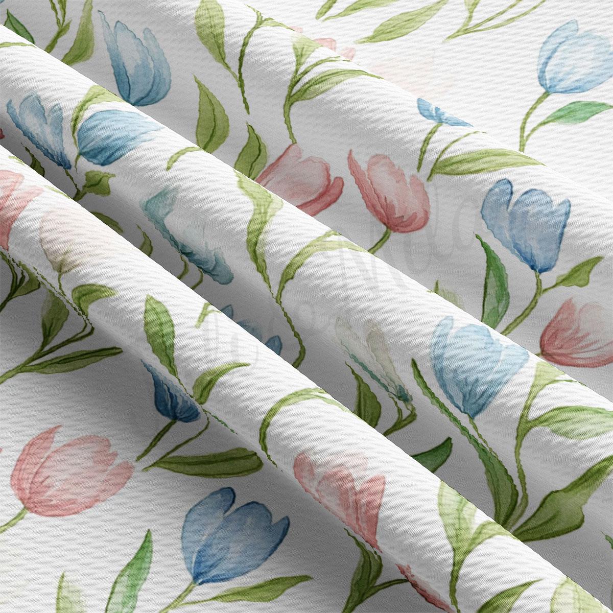 a close-up view of a fabric with a repeating floral pattern of blue, pink, and green flowers.