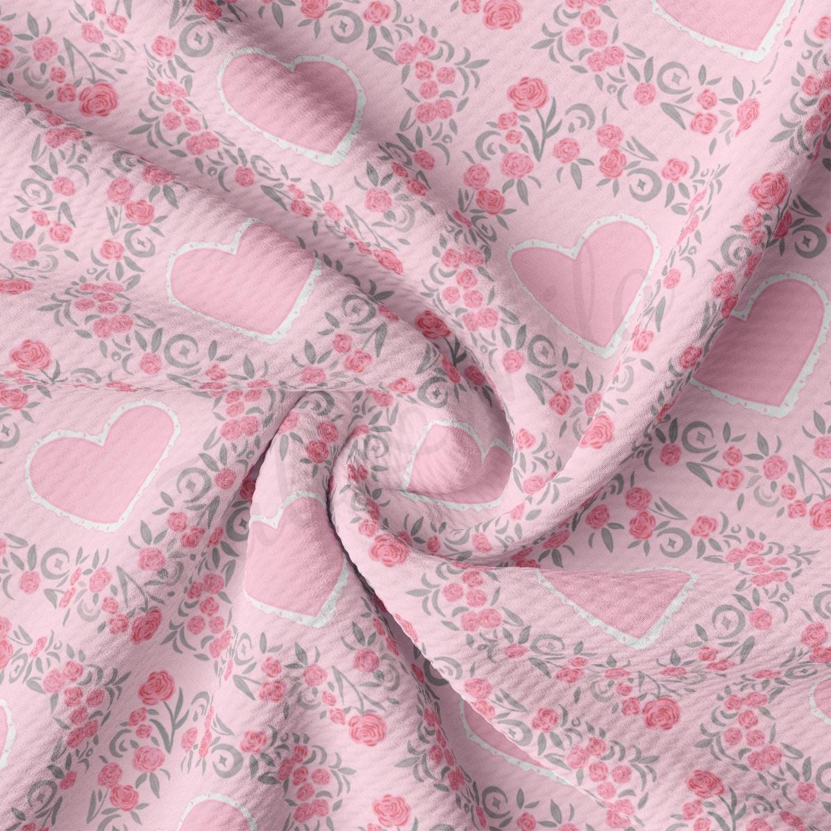 a pink fabric with hearts and flowers on it
