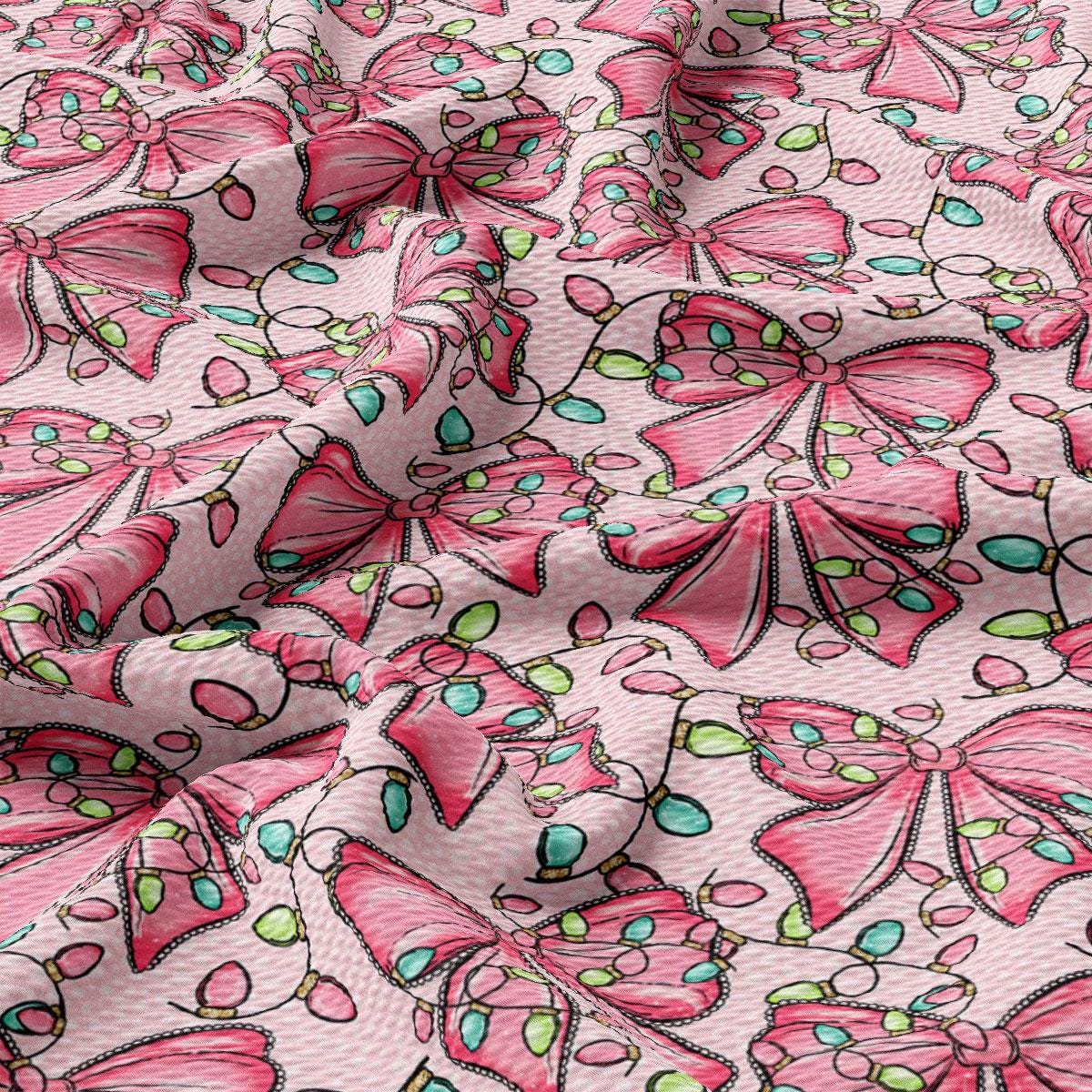 a close-up view of a fabric with a repeating pattern of pink bows and green leaves. The bows are arranged in a way that they overlap each other, creating a visually appealing and textured design. The green leaves add a touch of nature to the overall pattern, enhancing the overall aesthetic of the fabric.