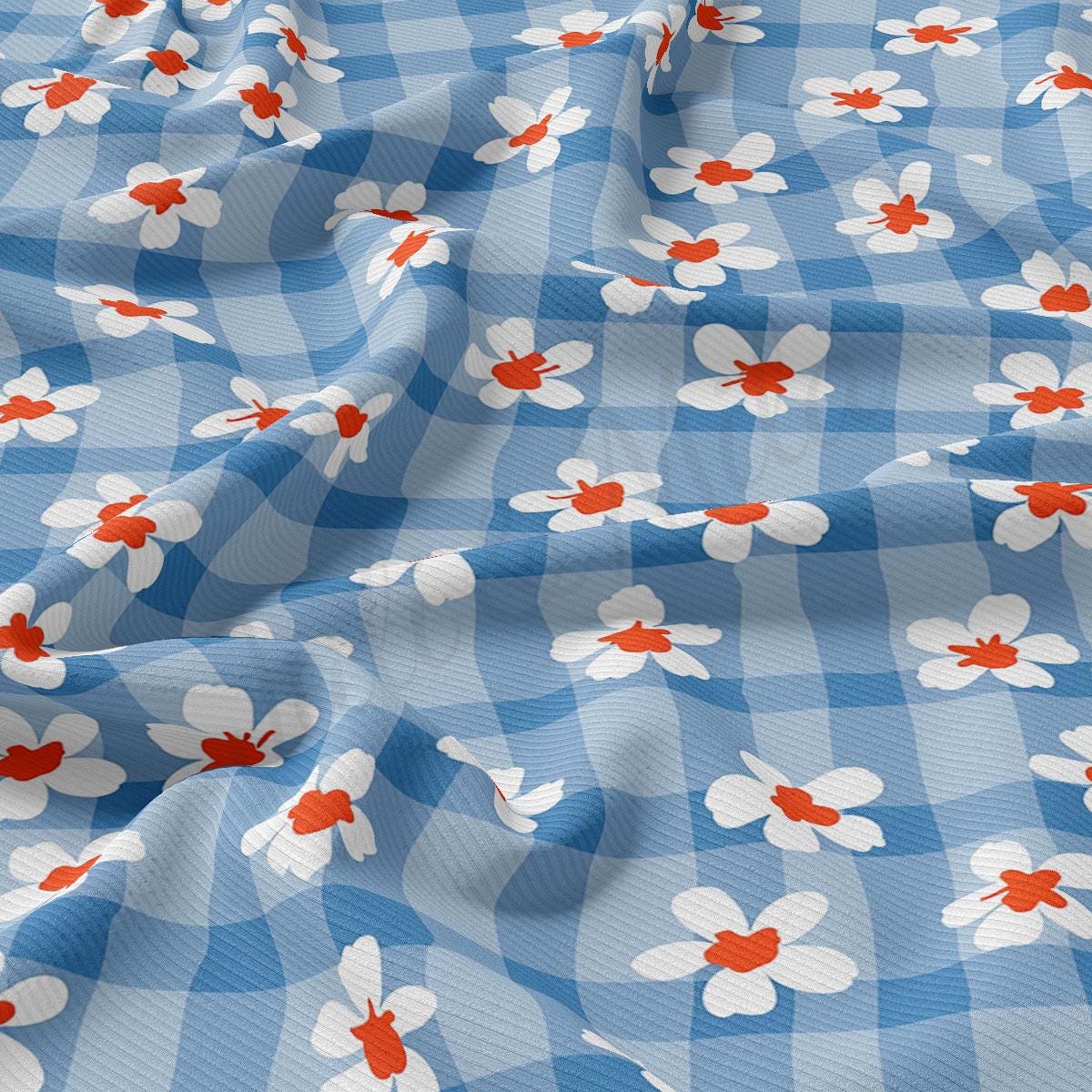 a blue and white checkered fabric with red and white flowers