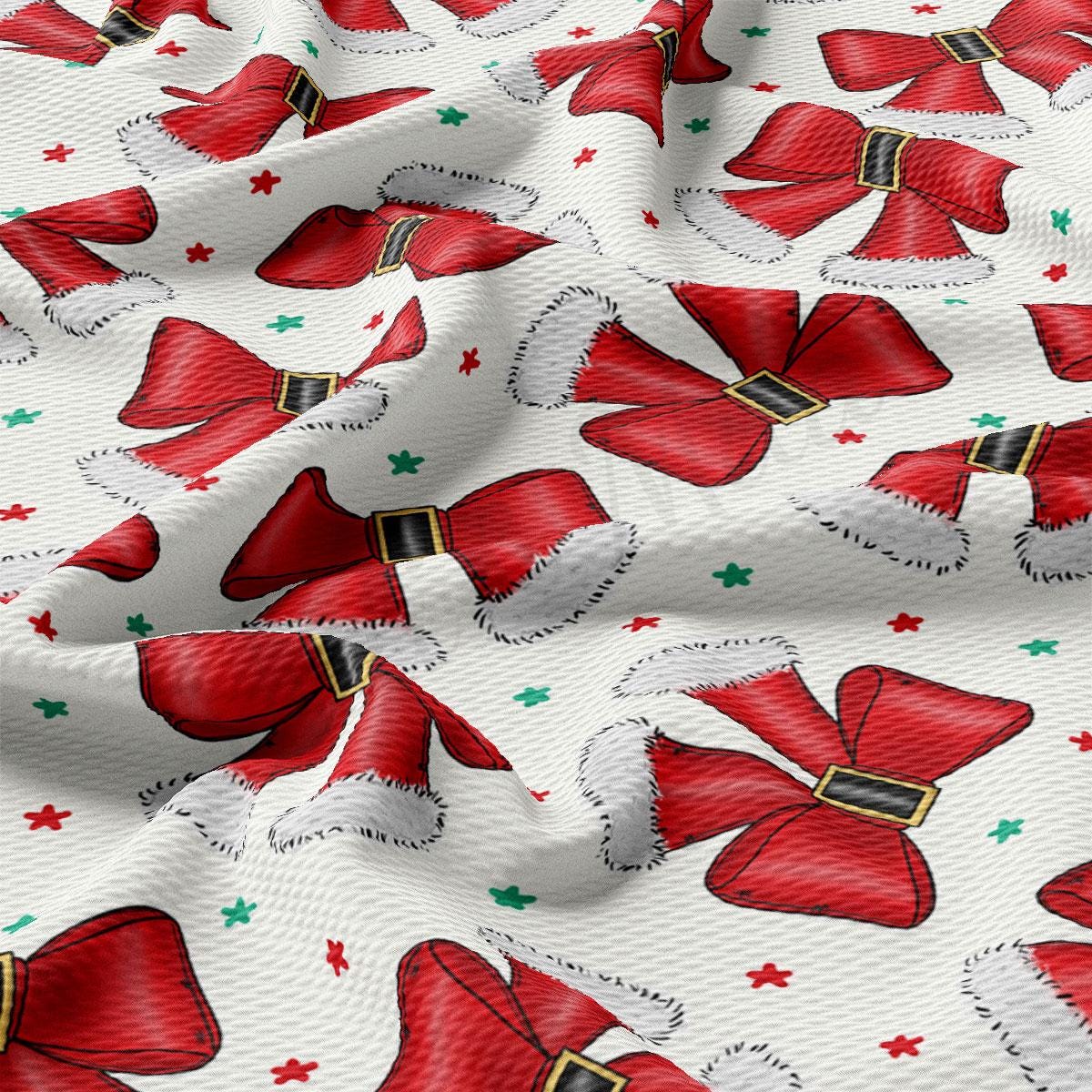 a close-up view of a fabric with a repeating pattern of red Santa hats and green stars.