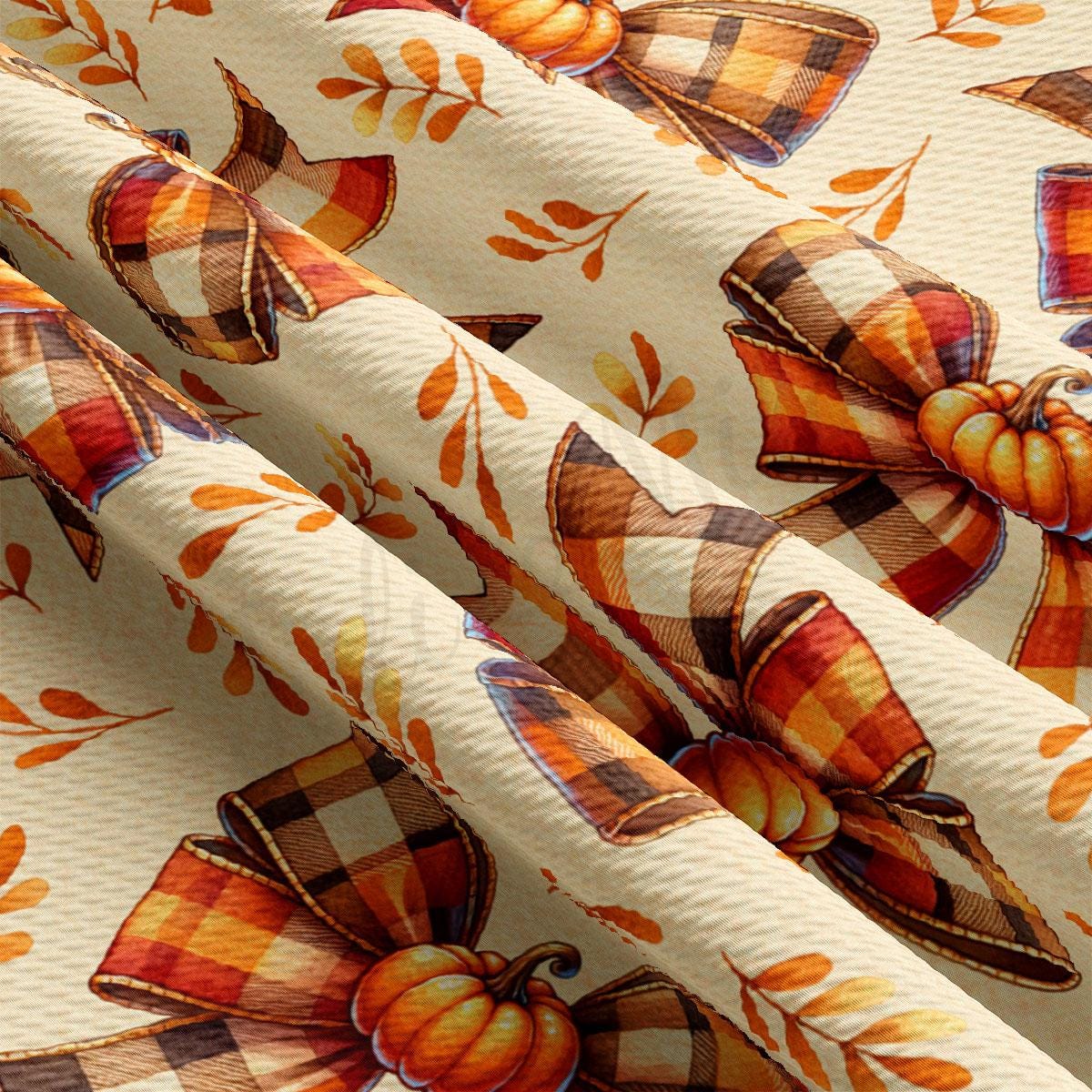 a fabric with a repeating pattern of plaid bows and pumpkins, creating a festive autumn-themed design.