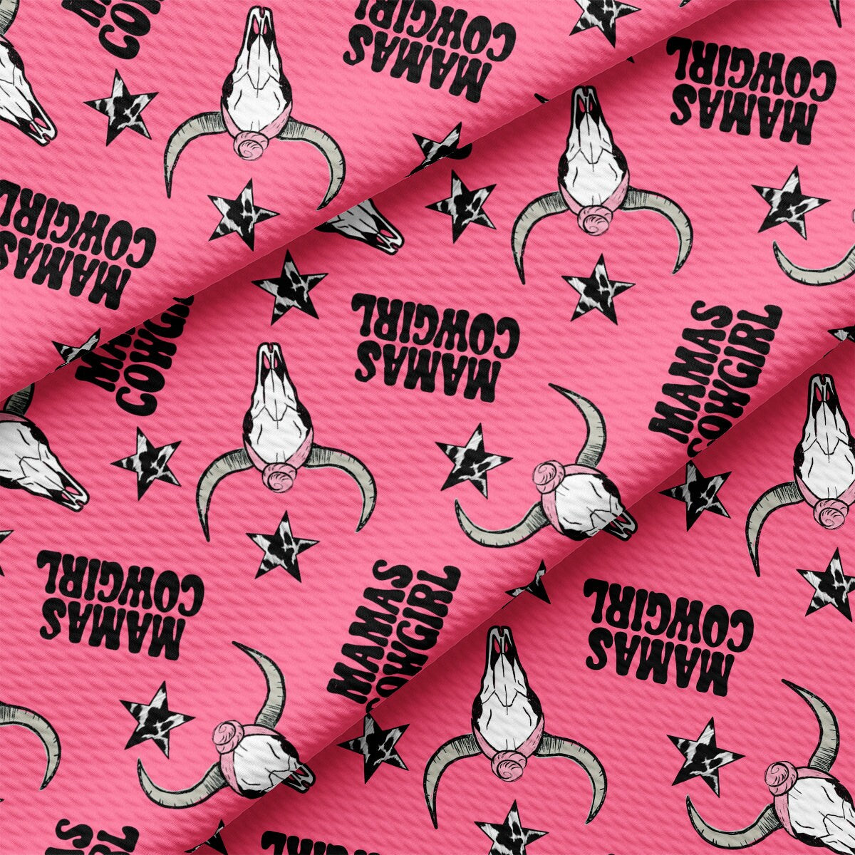 a pink fabric with black and white images on it