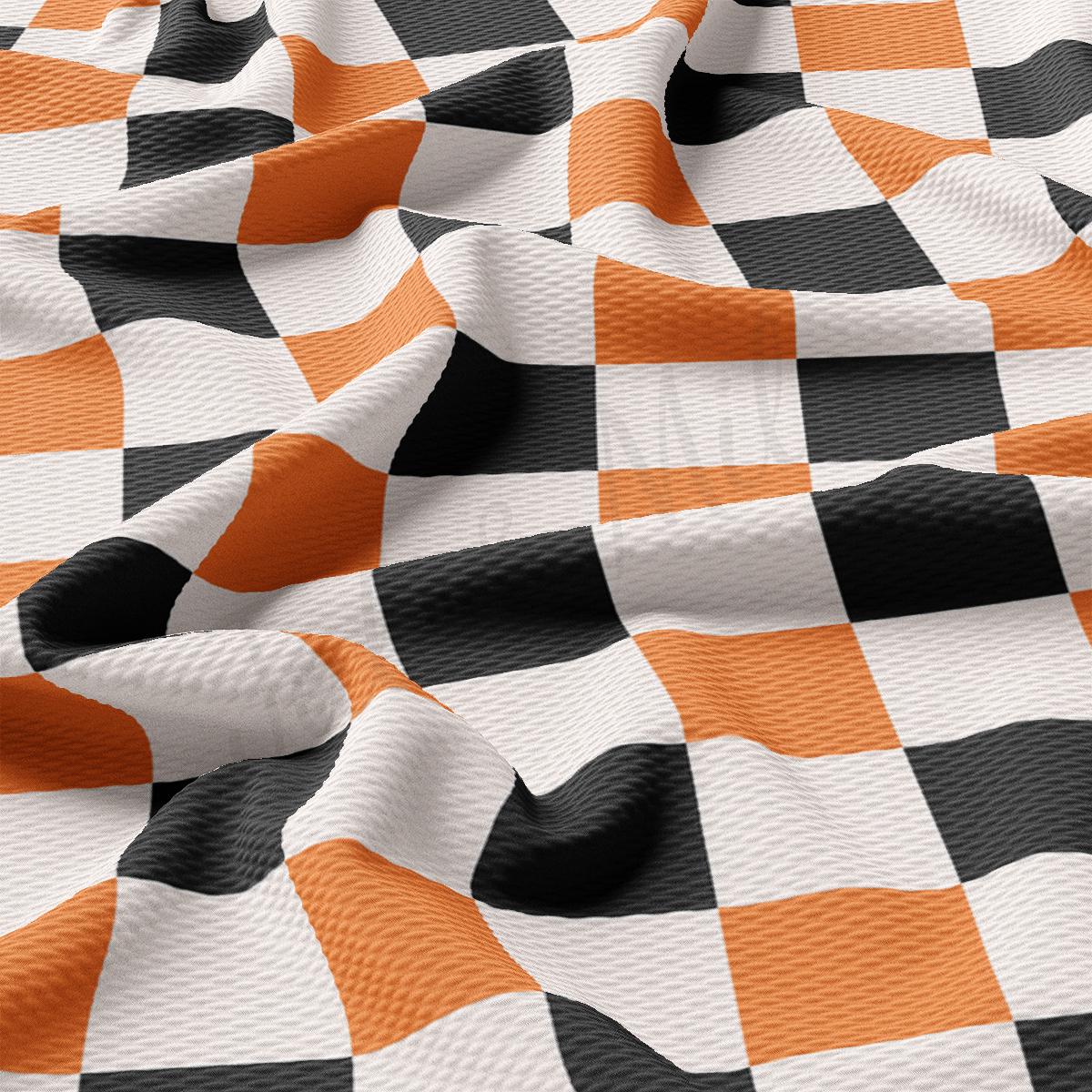 an orange and black checkered fabric with a white background