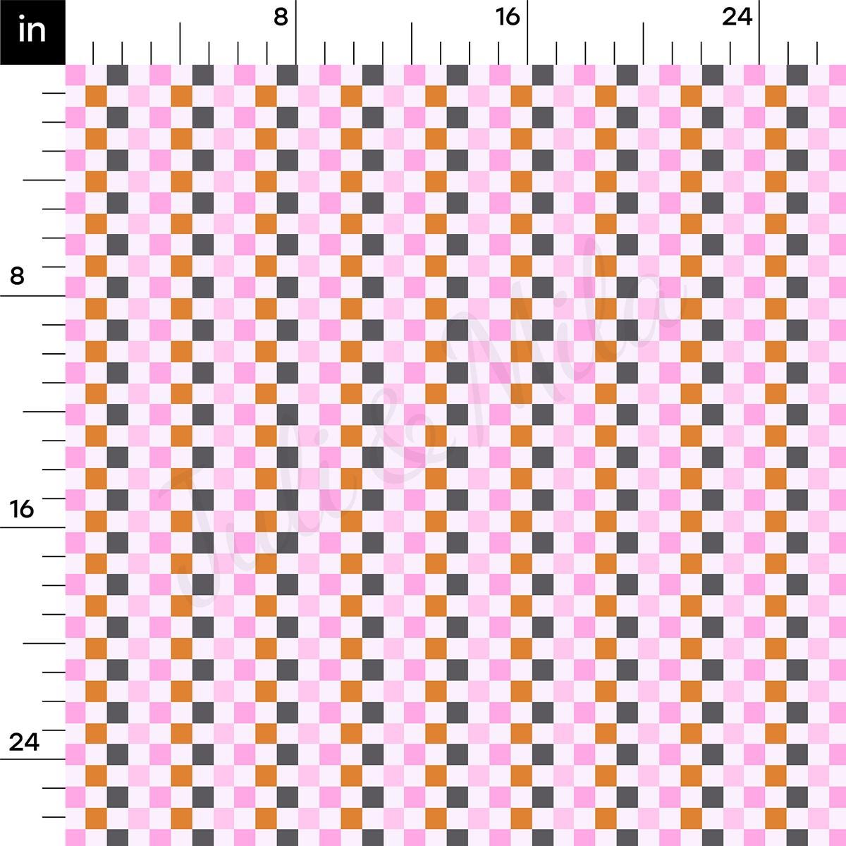 a ruler with a pink and orange checkerboard pattern