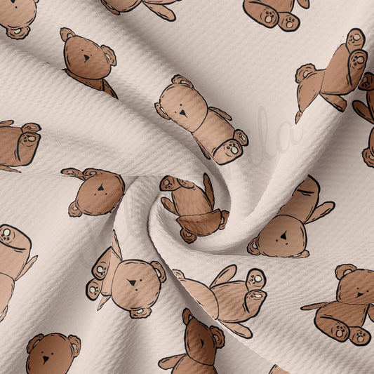a white fabric with brown teddy bears on it