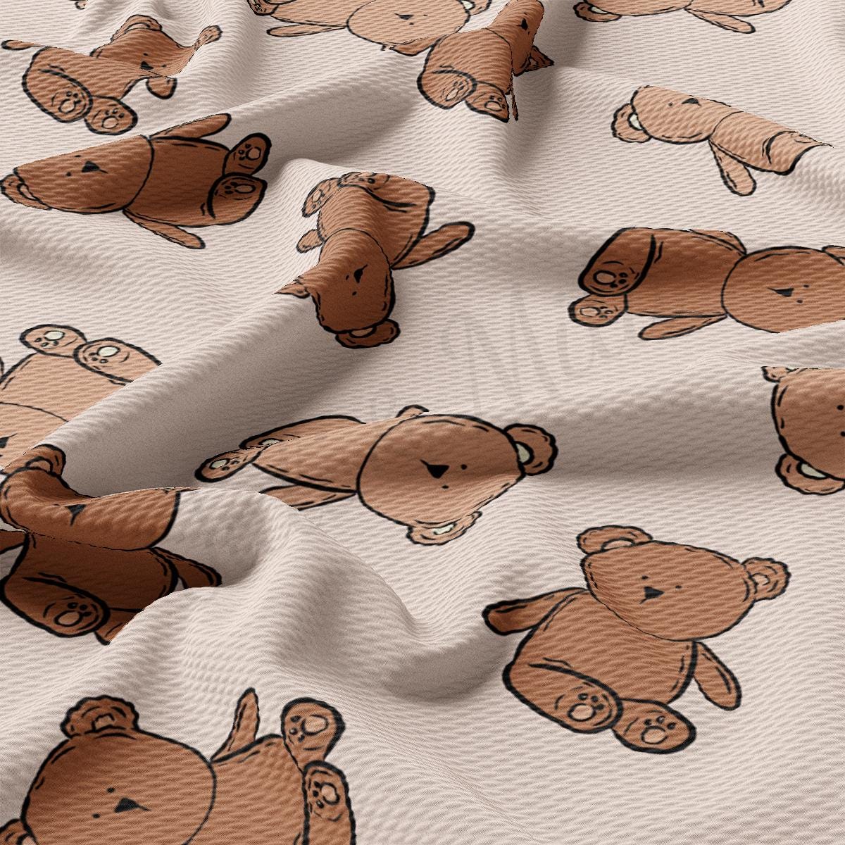 a white fabric with brown teddy bears on it
