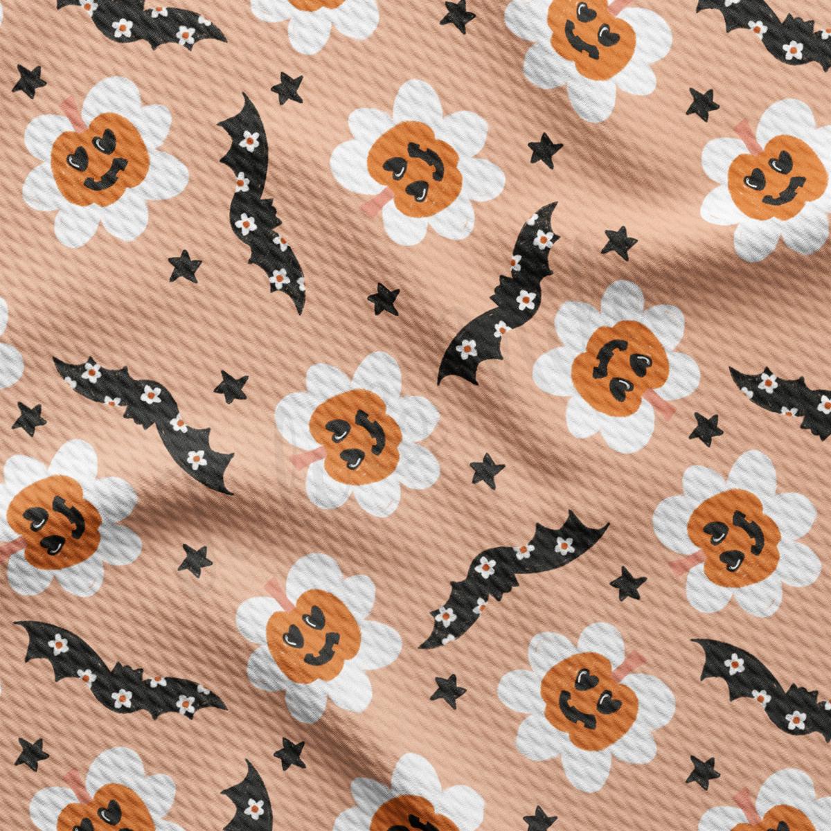 a pattern of bats and pumpkins on a pink background
