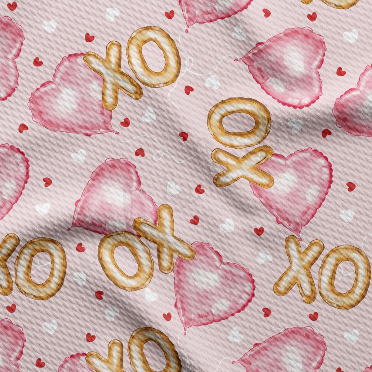 a close up of a pink background with gold letters and hearts