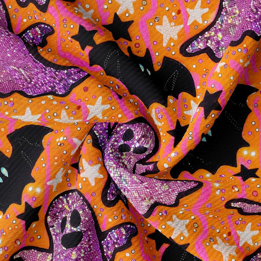a purple and orange fabric with skulls and stars on it