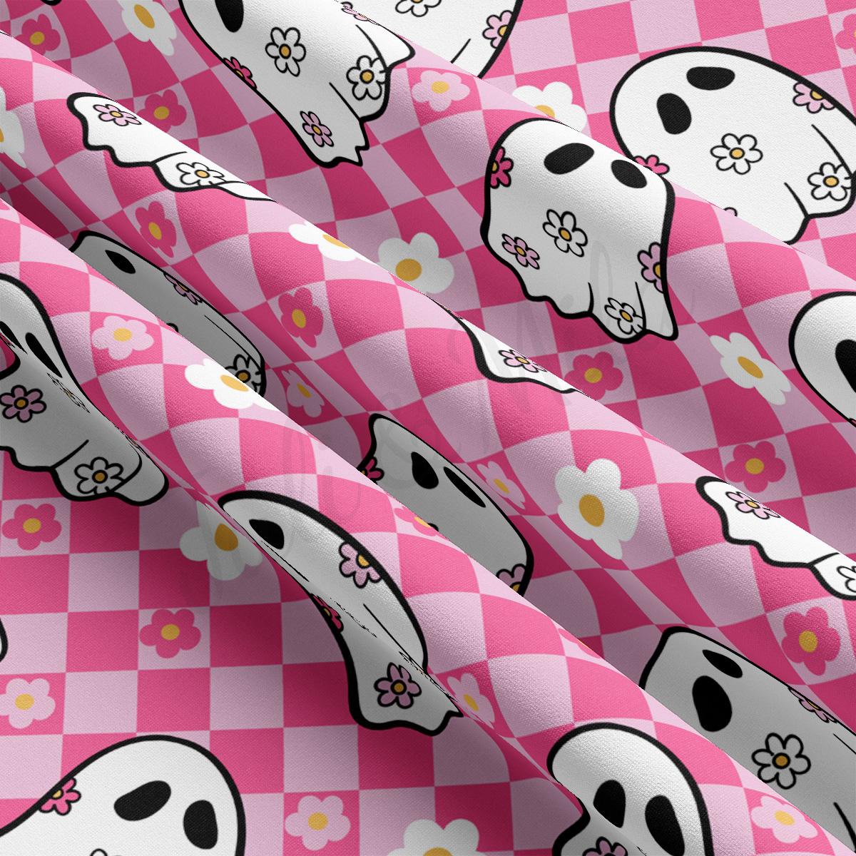 a pink and white checkered pattern with skulls and flowers