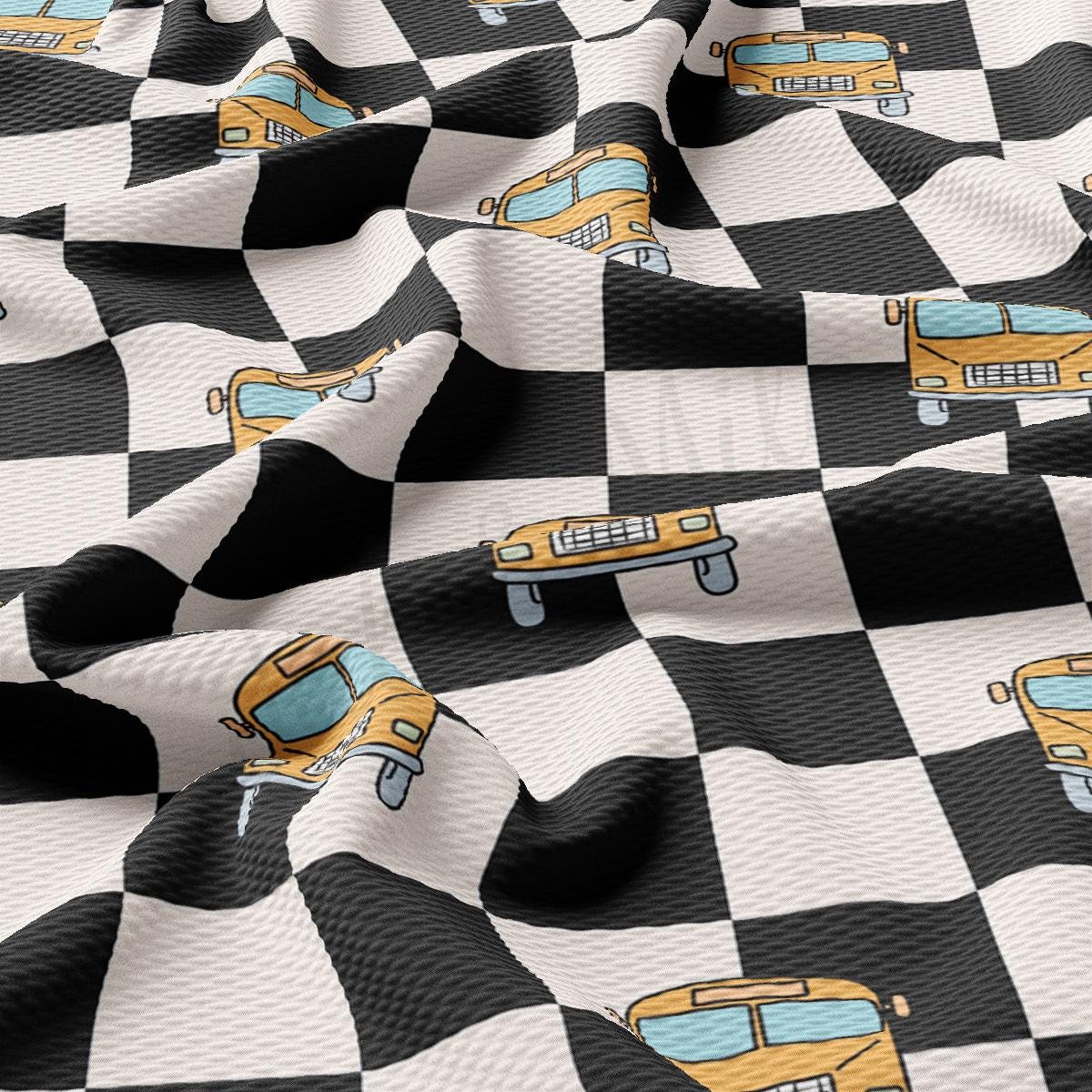 a black and white checkered fabric with yellow school buses on it
