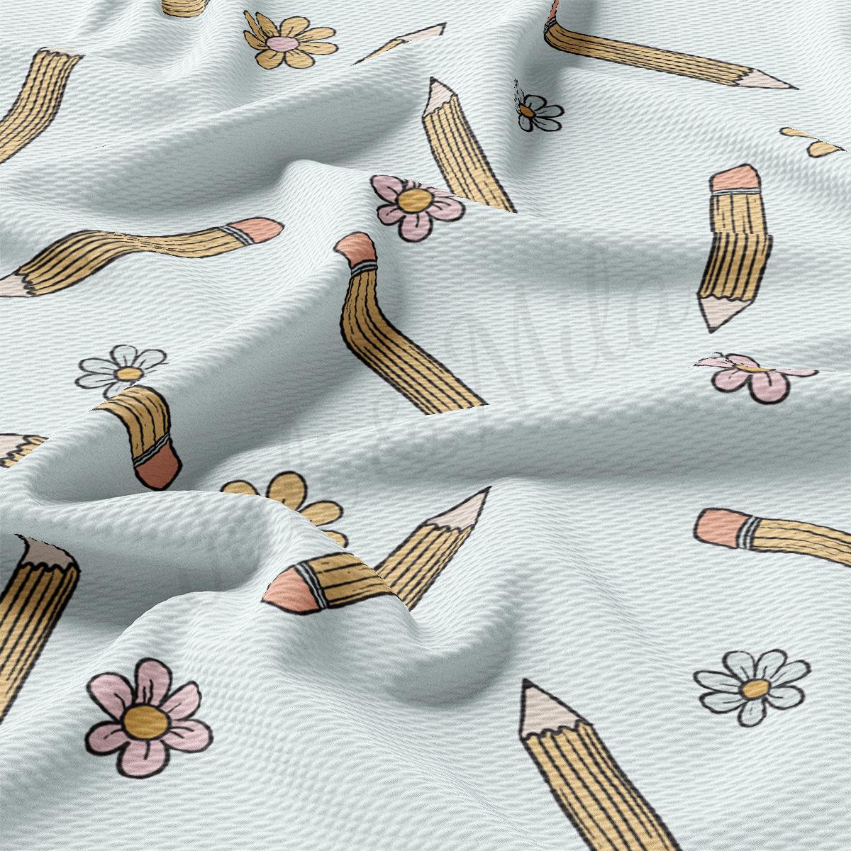 a white fabric with pencils and flowers on it