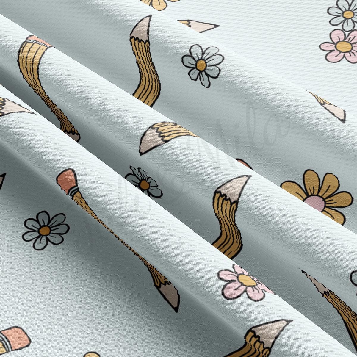 a close up of a white fabric with flowers and arrows
