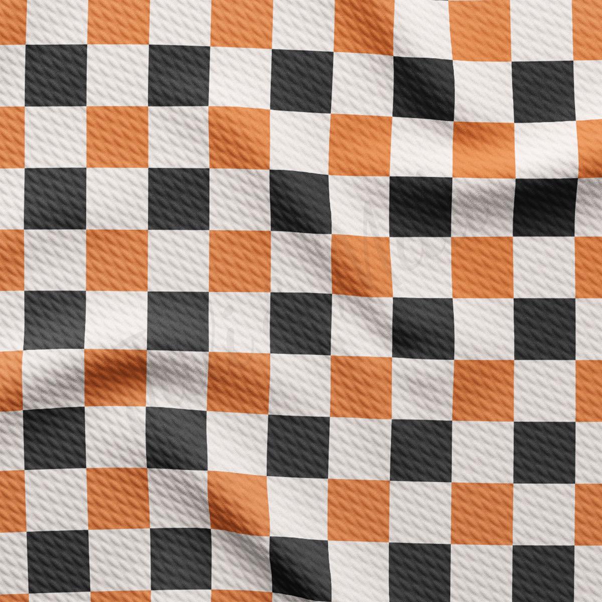 an orange and black checkered fabric is shown