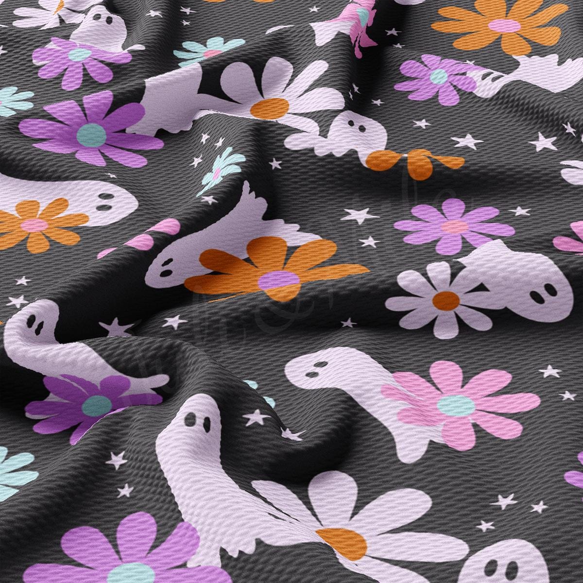 a close up of a fabric with flowers and skulls on it