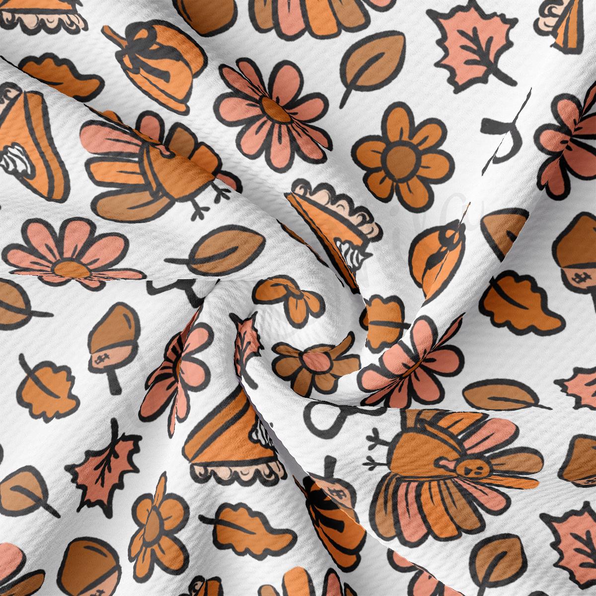 a close up of a white fabric with orange and brown flowers
