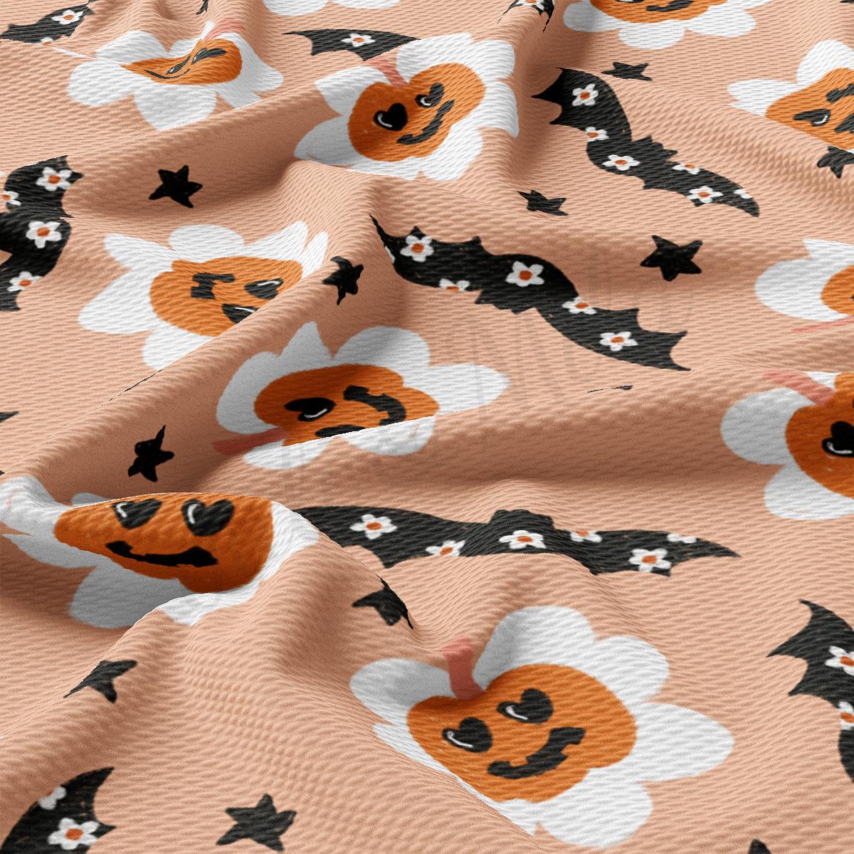 a pattern of bats and pumpkins on a pink background