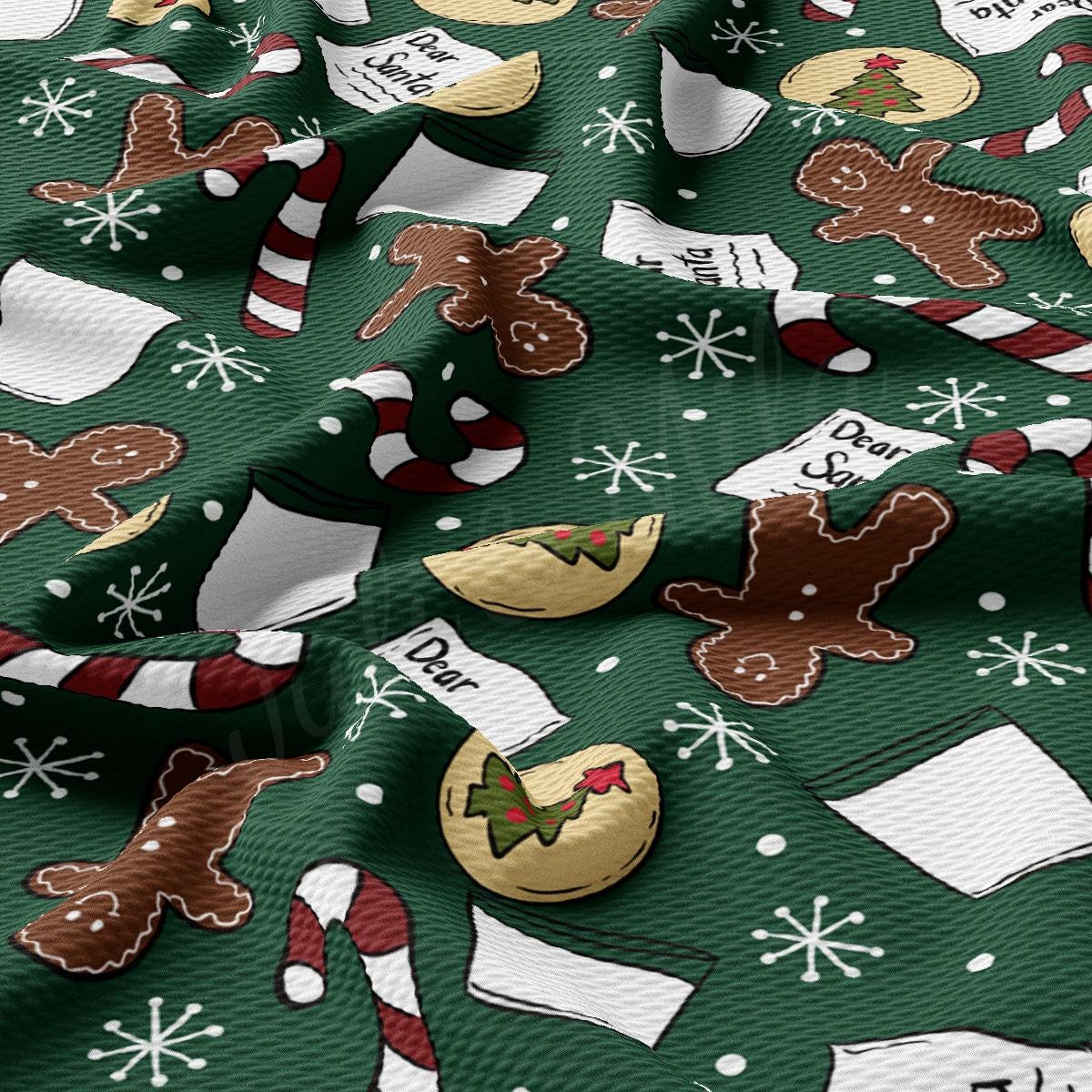 a close up of a green fabric with christmas decorations on it